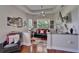 Sitting room with hardwood floors, a ceiling fan, a black leather couch and a view into the backyard at 13102 Done Groven Dr, Dover, FL 33527
