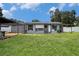 Backyard featuring a covered patio area with outdoor seating and a white privacy fence at 15906 Country Farm Pl, Tampa, FL 33624