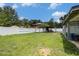 Expansive backyard enclosed by a white fence, offering plenty of space for outdoor entertainment at 15906 Country Farm Pl, Tampa, FL 33624