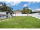 Large backyard with a white privacy fence and a gray shed for outdoor storage at 15906 Country Farm Pl, Tampa, FL 33624
