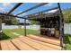Backyard with a wooden pergola, string lights and views of the yard at 15906 Country Farm Pl, Tampa, FL 33624