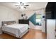 Cozy bedroom features wood laminate floors, ceiling fan, and closet at 15906 Country Farm Pl, Tampa, FL 33624