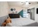 Cozy bedroom features wood laminate floors, ceiling fan, and closet at 15906 Country Farm Pl, Tampa, FL 33624