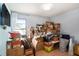Bedroom filled with moving boxes, natural light, and a mounted television at 15906 Country Farm Pl, Tampa, FL 33624
