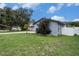 Well-maintained exterior of a gray home with a neatly manicured lawn at 15906 Country Farm Pl, Tampa, FL 33624