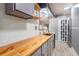 Stylish kitchen with wood countertops, gray cabinets, and modern appliances at 15906 Country Farm Pl, Tampa, FL 33624