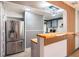 Modern kitchen featuring stainless steel refrigerator and breakfast bar with wood countertop at 15906 Country Farm Pl, Tampa, FL 33624