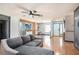 Spacious living room with hardwood floors, a view to the dining area and lots of natural light at 15906 Country Farm Pl, Tampa, FL 33624