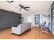 Comfortable living room featuring a sofa, chairs, sliding glass doors, and modern ceiling fan at 15906 Country Farm Pl, Tampa, FL 33624