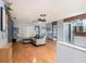 Bright living room with an open floor plan, hardwood floors, modern decor, and sliding glass doors at 15906 Country Farm Pl, Tampa, FL 33624