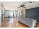 Inviting living room with hardwood floors, a stylish sofa, and modern ceiling fan at 15906 Country Farm Pl, Tampa, FL 33624