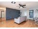 Open living room with hardwood floors, a sofa, and access to the dining area at 15906 Country Farm Pl, Tampa, FL 33624