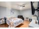 Bright main bedroom with ceiling fan, television, and decorative monogrammed wall decor at 15906 Country Farm Pl, Tampa, FL 33624