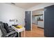 Spacious room featuring an office setup, wood flooring, and gray accent door at 15906 Country Farm Pl, Tampa, FL 33624