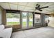 Enclosed sunroom with a ceiling fan and views of the backyard at 15906 Country Farm Pl, Tampa, FL 33624