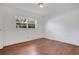 Bright bedroom featuring hardwood floors and a large window offering natural light at 1600 Amberlea N Dr, Dunedin, FL 34698