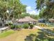 Charming community clubhouse with lush landscaping and a welcoming entrance for residents to gather and enjoy at 1600 Amberlea N Dr, Dunedin, FL 34698