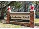 Amberlea Park community sign with brick pillars and decorative toppers in a sunny, landscaped setting at 1600 Amberlea N Dr, Dunedin, FL 34698