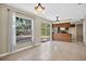 Bright dining area featuring tile floors, a sliding door to the backyard, and a view to the kitchen at 1600 Amberlea N Dr, Dunedin, FL 34698