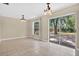 Bright dining area featuring tile floors and a sliding door to the backyard at 1600 Amberlea N Dr, Dunedin, FL 34698