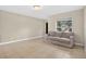 Inviting living room with neutral-toned walls, tile flooring, and a comfortable sofa at 1600 Amberlea N Dr, Dunedin, FL 34698