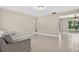 Spacious living room with tile flooring and glass sliding doors to the backyard at 1600 Amberlea N Dr, Dunedin, FL 34698