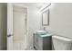 Bathroom with modern vanity, faucet, and a doorway to another room at 16138 Manorwood Cir, Tampa, FL 33624