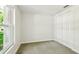 Bright, carpeted bedroom with a large window and double closet at 16138 Manorwood Cir, Tampa, FL 33624