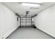 Empty garage with a garage door that's partially opened at 16138 Manorwood Cir, Tampa, FL 33624