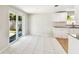 Bright kitchen area featuring tile floors, sliding glass doors, white cabinets, and granite countertops at 16138 Manorwood Cir, Tampa, FL 33624