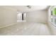 Spacious living area with large windows, tile flooring, neutral colored walls, and natural light at 16138 Manorwood Cir, Tampa, FL 33624