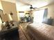 Comfortable bedroom featuring a bed, desk, and sliding glass door, ideal for relaxation and productivity at 1814 Driftwood S Cir, Oldsmar, FL 34677