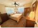 Cozy bedroom with a comfortable bed, neutral tones, warm lighting, and traditional wood furniture creating a relaxing space at 1814 Driftwood S Cir, Oldsmar, FL 34677