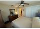 Neutral bedroom with a double bed, closet, and dresser creating a simple and functional living space at 1814 Driftwood S Cir, Oldsmar, FL 34677