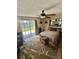 Well-lit bedroom featuring a sliding glass door and an office setup, perfect for work and relaxation at 1814 Driftwood S Cir, Oldsmar, FL 34677