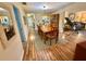 Open-concept dining room with wood floors, a dining table set, and access to other living areas at 1814 Driftwood S Cir, Oldsmar, FL 34677