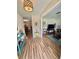 Bright entryway with wood floors and view to living room with a television at 1814 Driftwood S Cir, Oldsmar, FL 34677