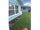 Charming home exterior featuring vibrant flower beds, lush green grass, and tidy landscaping, enhancing curb appeal at 1814 Driftwood S Cir, Oldsmar, FL 34677
