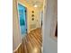 Hallway with hardwood floors offering views to bedrooms and other areas of the home at 1814 Driftwood S Cir, Oldsmar, FL 34677