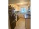 Charming kitchen with stone countertops, stainless steel appliances, tile backsplash, and updated cabinetry at 1814 Driftwood S Cir, Oldsmar, FL 34677