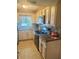 Updated kitchen featuring tile floors, stone countertops, stainless steel appliances, and mosaic tile backsplash at 1814 Driftwood S Cir, Oldsmar, FL 34677