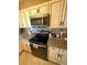 Updated kitchen showcasing stone countertops, stainless steel appliances, and updated cabinets at 1814 Driftwood S Cir, Oldsmar, FL 34677