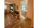 Open-concept living area with built-in shelving, entertainment unit, and a view of the bedroom adding a versatile design at 1814 Driftwood S Cir, Oldsmar, FL 34677