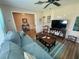 Open living room with wood floors and ample seating, perfect for entertaining at 1814 Driftwood S Cir, Oldsmar, FL 34677