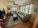 Spacious living room with wood flooring, seating, and lots of natural light at 1814 Driftwood S Cir, Oldsmar, FL 34677
