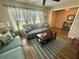 Comfortable living room featuring wood flooring and soothing color palette at 1814 Driftwood S Cir, Oldsmar, FL 34677
