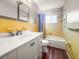 Bathroom featuring a single sink vanity, a bathtub, and yellow tiling at 1848 68Th N Ave, St Petersburg, FL 33702