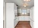 Classic kitchen featuring white cabinetry, wood floors, and ample counter space at 1848 68Th N Ave, St Petersburg, FL 33702