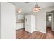 Bright kitchen featuring white cabinets, wood floors, and a large refrigerator at 1848 68Th N Ave, St Petersburg, FL 33702