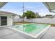 Backyard pool, concrete deck and white fencing at 1848 68Th N Ave, St Petersburg, FL 33702